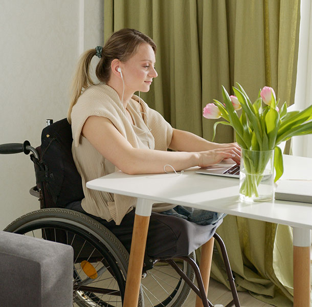 young woman in a wheelchair on a laptop