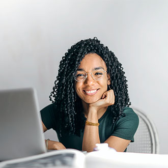 woman smiling working on a laptop